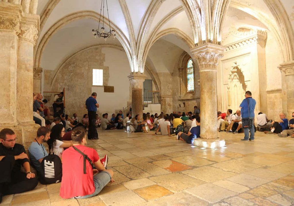 Peregrinos cristianos en la sala del Cenáculo en Jerusalén